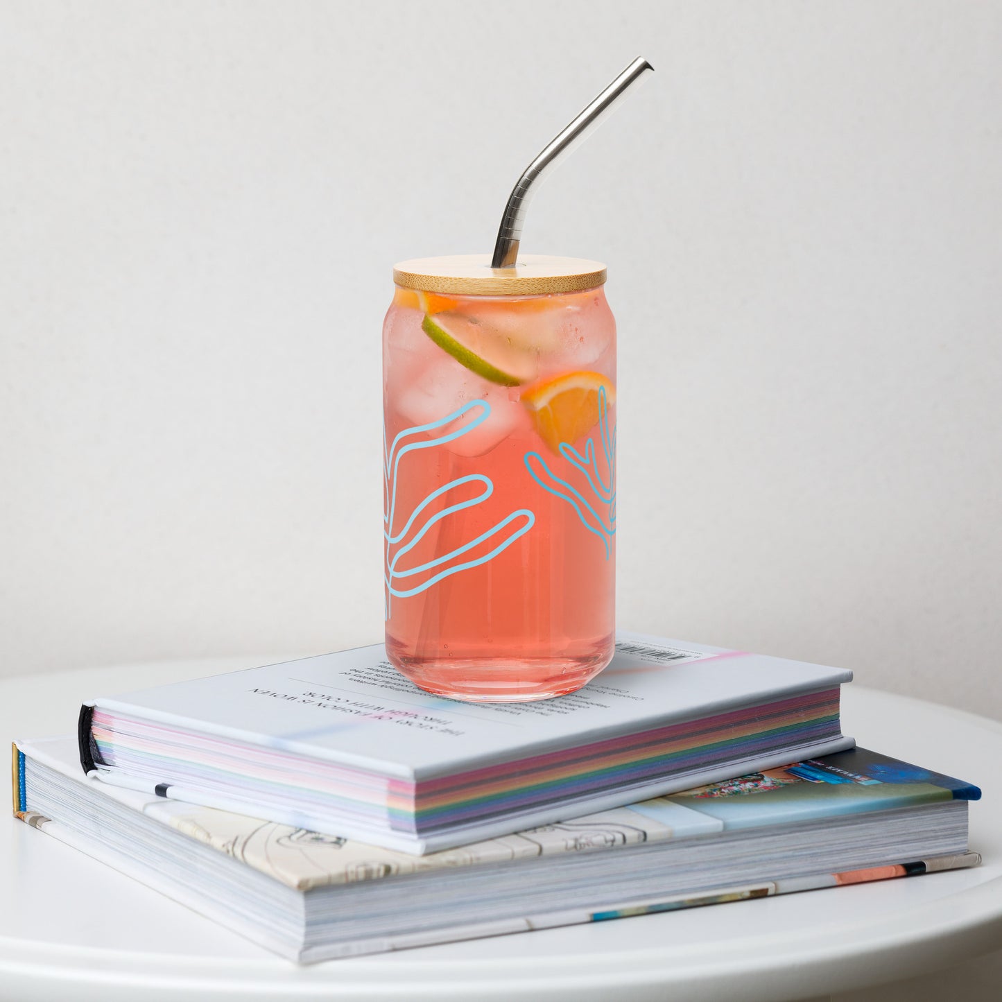 a coffee cup sitting on top of a stack of books 