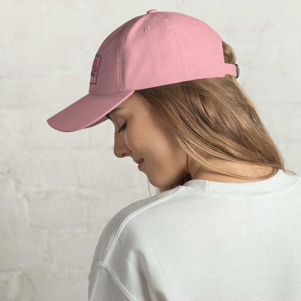 a young girl wearing a pink hat on her head 